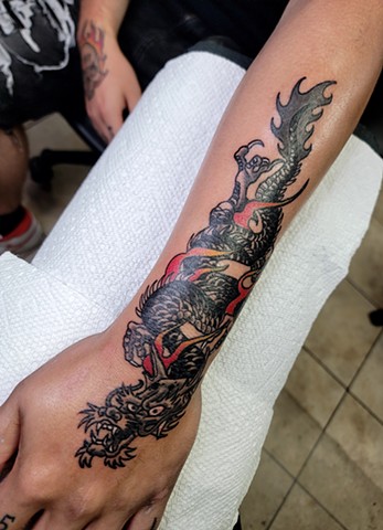 Traditional black and grey Japanese dragon on Hand and forearm by Gina Matsuo of Copper Fox Tattoo in Kissimmee Florida best tattoo shop near me