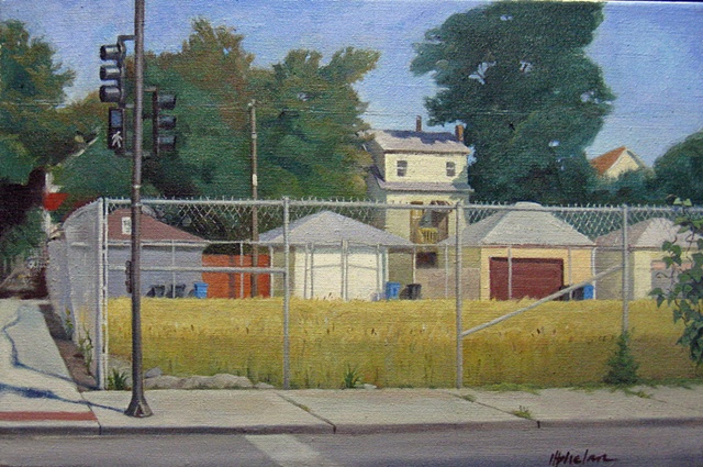 urban corner with empty lot surrounded by chainlink fence and view of garages and trees in late summer  by Mary Phelan