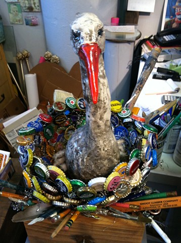 stork on a found object nest