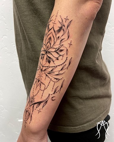 This is a delicate sacred moon magick ornamental tattoo done with a fine line in black and grey by female tattoo artist tarot reader and witch Amanda Marie at her tattoo and tarot studio in central New York Scipio center Cayuga Ithaca nature floral orname