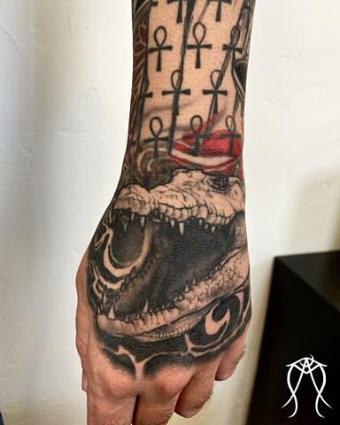 This is a tarot tower sleeve geometric tattoo featuring mandalas Anubis Ammit Egyptian deities and Art the scarab beetle this tattoo represents death transformation rebirth decay magick it is sacred and spiritual and done in black and grey and red by fema