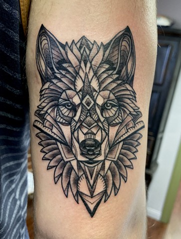 this is a geometric tattoo of a wolf done by Amanda Marie female tattoo artist and tarot reader in los Angeles California at her private studio ace of wands tattoo