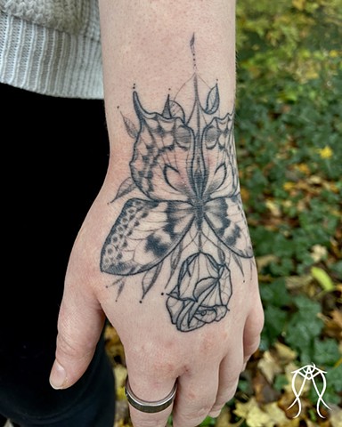 This is a rose butterfly spirit magick tattoo done by Amanda Marie pagan tattoo artist female tarot reader in her private studio ace of wands tattoo in Scipio center New York Ithaca east coast tattoo done in black and grey floral ornamental nature tattoos