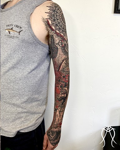 This is a tarot tower sleeve geometric tattoo featuring mandalas Anubis Ammit Egyptian deities and Art the scarab beetle this tattoo represents death transformation rebirth decay magick it is sacred and spiritual and done in black and grey and red by fema