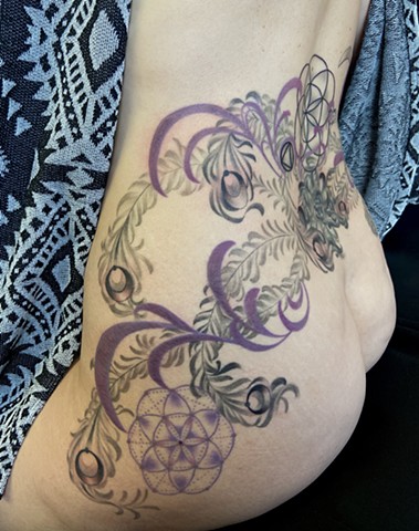 this is a tattoo of a mystical Phoenix rising from the ashes carrying magic and wisdom done in black and grey with a hint of color by Amanda Marie female tattoo artist and tarot reader in Los Angeles California at her private studio ace of wands tattoo 