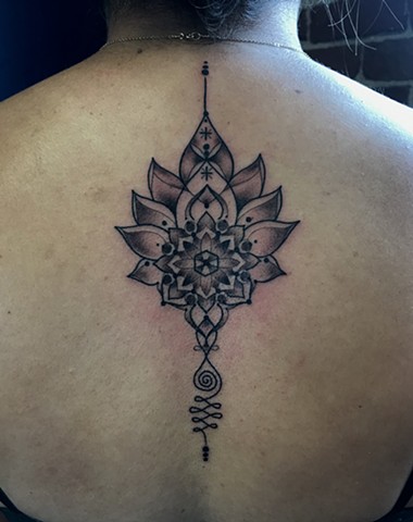 this is a spiritual lotus unalome tattoo done by Amanda Marie tattoo artist in Los Angeles San Pedro California at upscale private ace of wands tattoo it features a mandala 
