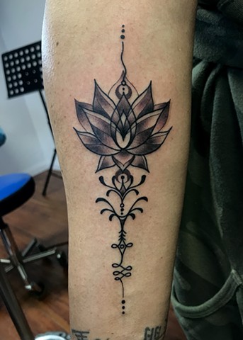 this is a unalome tattoo that includes a lotus on the path to enlightenment done in black and grey by Amanda Marie tattoo artist and owner of ace of wands tattoo in San Pedro California Los Angeles sacred space for art and tattooing 