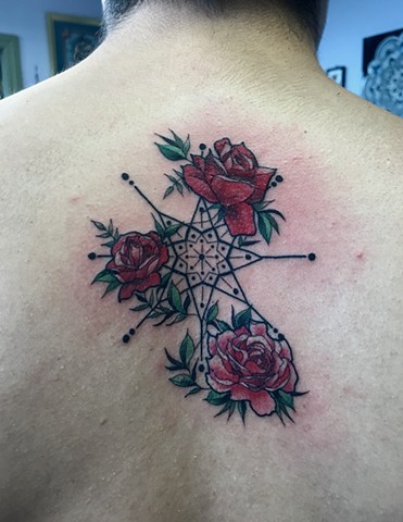 this is a tattoo of roses climbing up the wheel of fortune drawn with a star inspiration done by amanda marie tattooer female artist in san pedro los angeles california at ace of wands tattoo private tattoo studio that is a sacred space for spiritual tatt