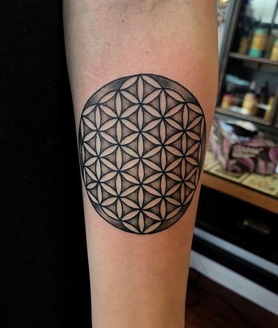 this is a tattoo of the flower of life done in black and grey by Amanda Marie female tattoo artist and owner of ace of wands private tattoo studio and sacred space 