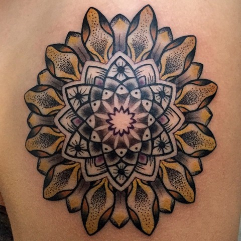 this is a sunflower mandala tattooed by amanda marie lady tattooer she will be tattooing at the boston tattoo convention and in salem massachusetts 