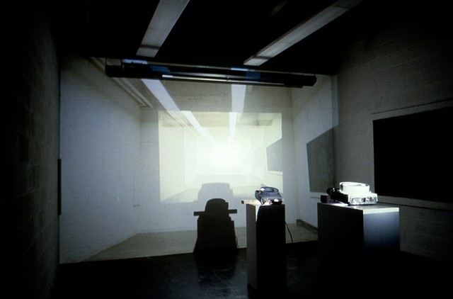 slide projector installation using 6 slide projectors projecting image of room inside of itself.