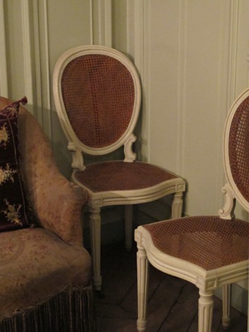Two cane chairs with silkscreen patterns from 'Neighbors' lightbox transferred to the seat and backing