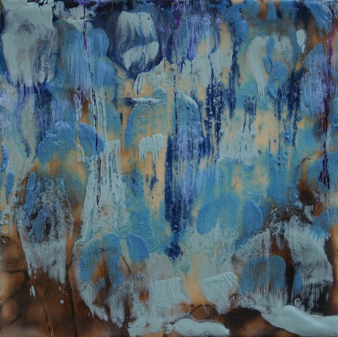  Waterfall in shades of blue over rocks outlined with sepia created with a wood burning tool. 