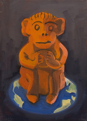 orange monkey sitting on image of earth