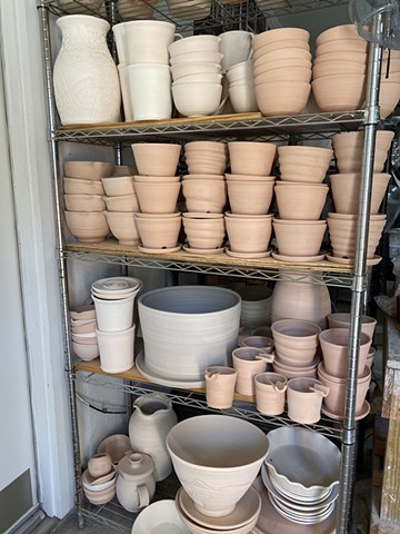 Pots in studio ready for glaze or bisque firing