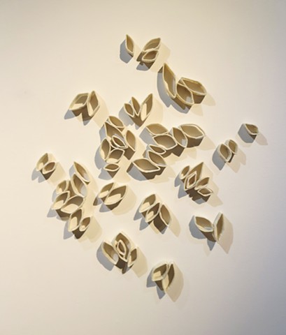 Contemporary seeds made of wool dipped in beeswax that create deep shadows.