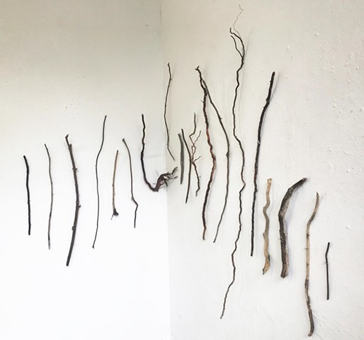 Found driftwood wall sculpture in a line shape drawing contrast 
