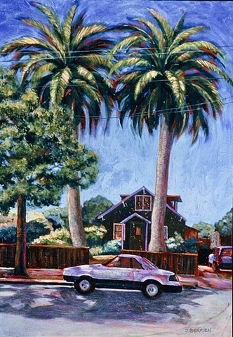A Berkeley street scene.  A small wooden house framed by two towering palms.