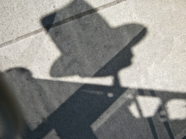 Digital photograph of light reflections and shadows on sidewalk 