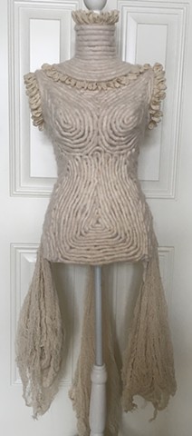 Bridal dress form with yarn and side drapes.