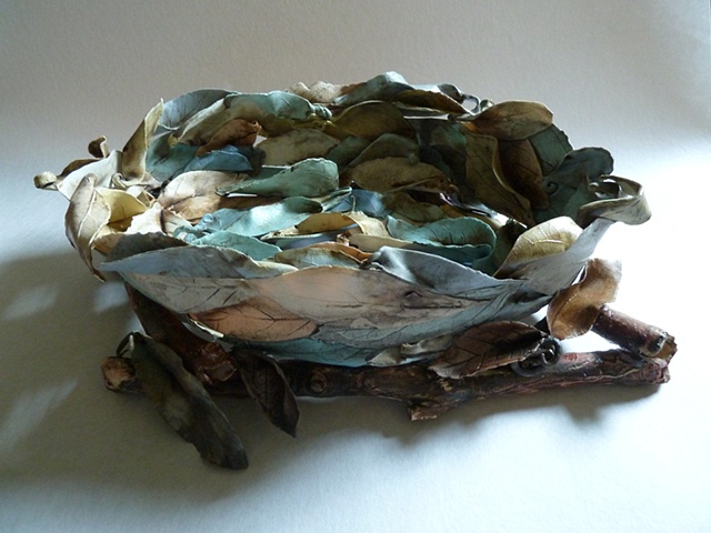 Porcelain leaves create this bowl resting on casted porcelain branches.