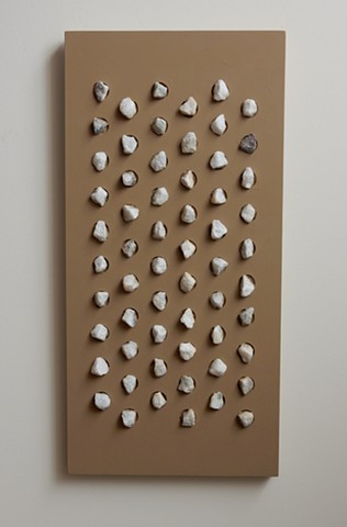 A wall relief, influenced by minimalism, situated somewhere between painting and sculpture. Acrylic paint and marble chips on a wood panel, 32-1/2 x 15-3/4 x 1-3/4 inches, by Robert Fields, 2015.