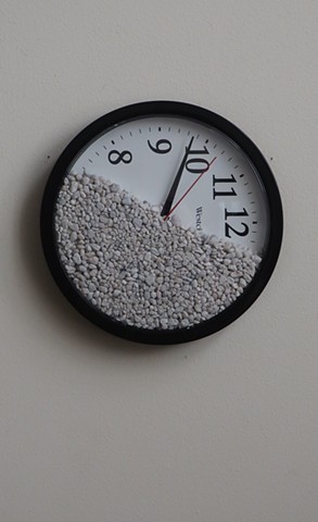 Robert Fields, Contemporary, conceptual art. Title: “L’me think… I remember now.” 2020. Medium: Wall clock with rock gravel (battery not included). 9-1/2" Diameter x 1-1/2" Deep.