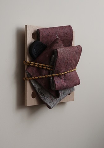 Robert Fields, Contemporary art, conceptual, minimal sculpture. 2020. Media: Felt with flip-flop, rubber sandal on wood panel, bound-up with a bungee cord. 16" H x 15" W x 4-1/2" D. Work informed by reading about survivors of trauma—whether abuse, acciden