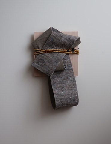 Minimal, contemporary sculpture. Robert Fields, "Untitled," 2019. Mixed fiber felt with latex foam backing, plywood panel and an elastic bungee cord. 26 H x 16 W x 7 D Inches. Contemporary artwork. Informed by stories of migration... the poems of Warsan S