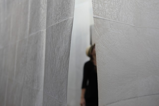 installation of suspended, woven, waxed paper walls hung from architectural skylight