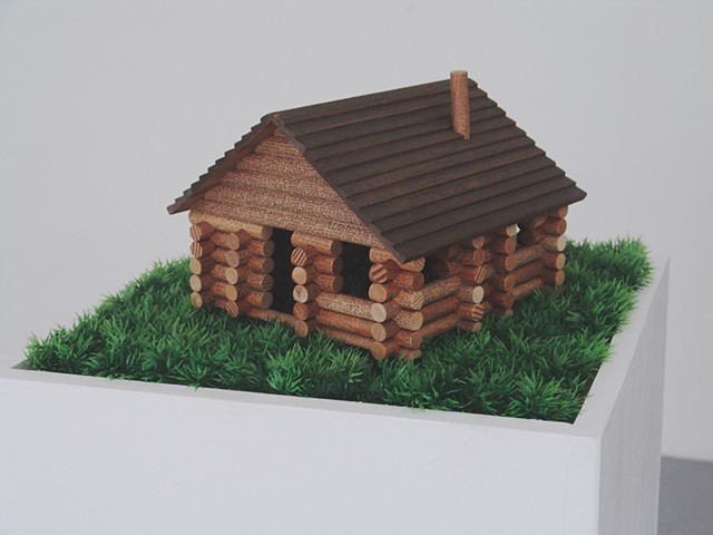 model log cabin kit with tiny text of the title repeated on it