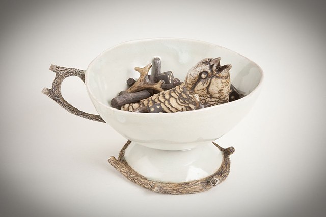 porcelain teacup with bird and sticks