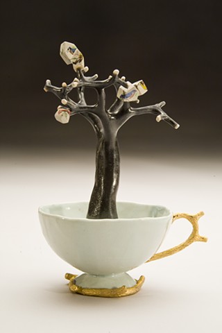 porcelain teacup with tree and houses