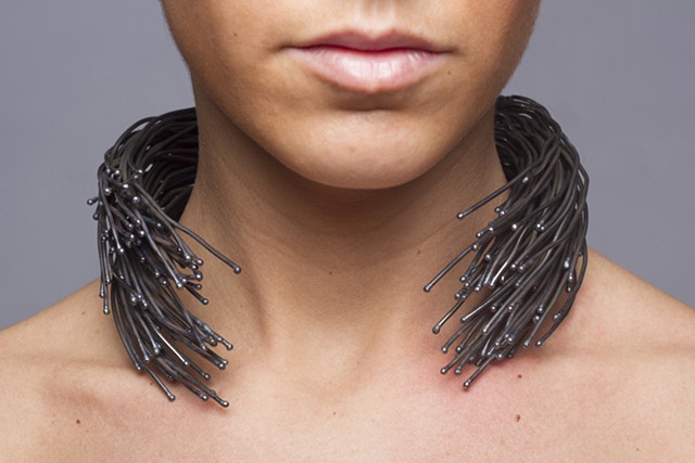 A sculptural one-of-a-kind forged wire neckpiece that is composed of welded steel