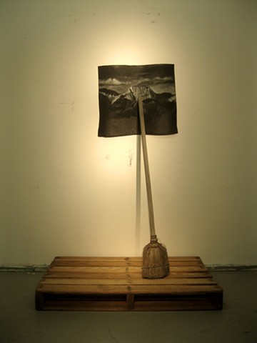 broom on a pallet that holds up a drawing of a generic mountain landscape, romanticism, individualism