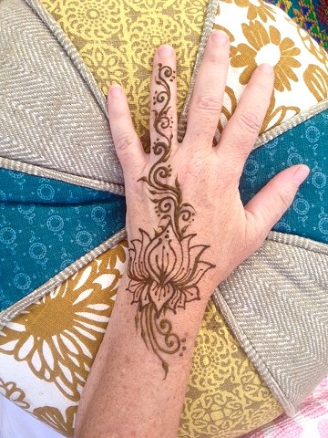 Henna hand with lotus and trailing vines