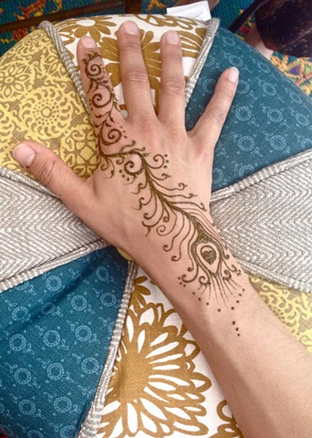 Henna hand with Peacock feather trail