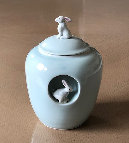 wheel thrown, celadon jar with porcelain bunny figures