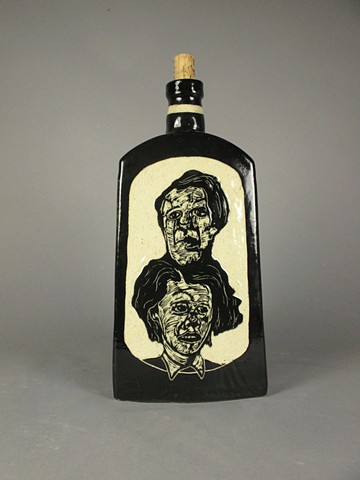 A double stack of heads is carved on each side of this ceramic bottle.
