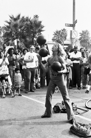 Venice Beach Ca. Side show bowling ball juggller