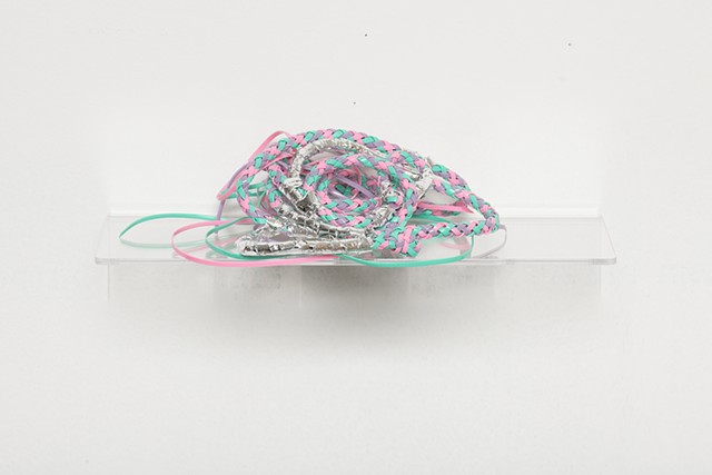 sculpture made with braided mint, pink, and lavender plastic lacing and silver mylar emergency blankets by José Santiago Pérez