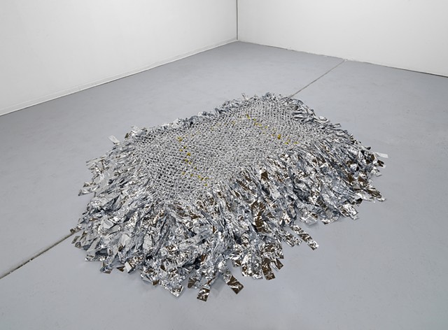 floor sculpture made from hand netted nylon and knotted mylar emergency blankets by José Santiago Pérez
