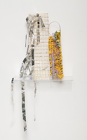 coiled sculpture with tangerine and lavender plastic lacing, gold leaf, plastic mesh, and silver mylar by José Santiago Pérez
