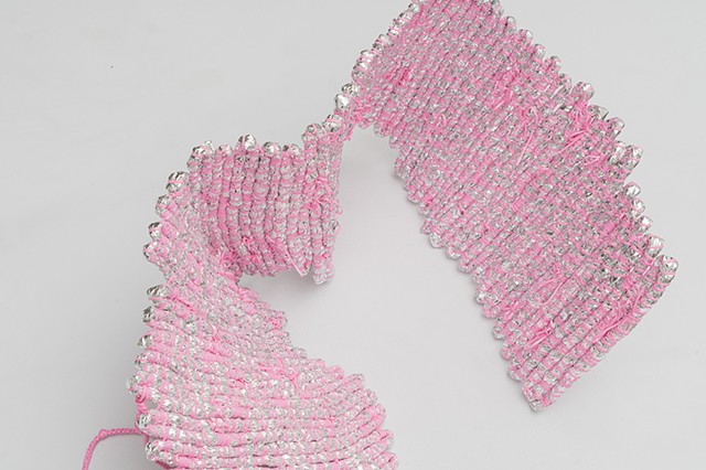 Detail of abstract coiled basket made with emergency blankets and pink plastic lacing by José Santiago Pérez