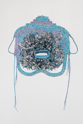 wall based abstract coiled basket made with emergency blankets and baby blue and lavender plastic lacing by José Santiago Pérez