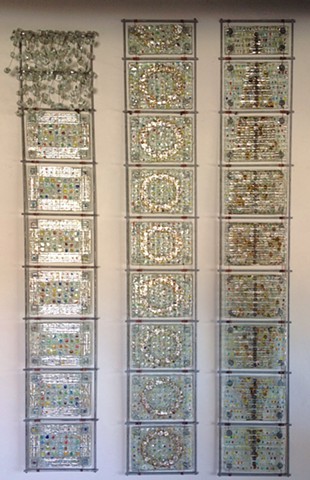fused glass, mica, wire, and bead panels arranged in three 54"x8" steel grids