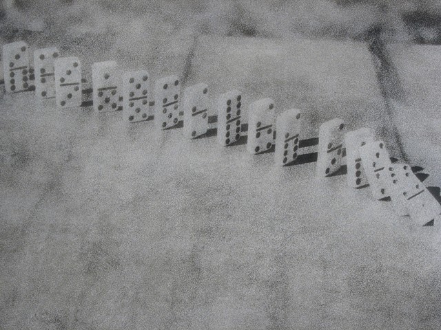 Photographic oil print of falling dominoes by E.E. Smith