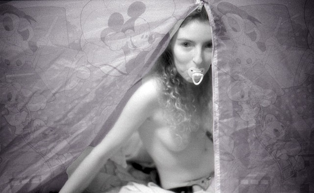 woman with pacifier in her mouth acting as a little photographed by La Mouge Erotic Photo