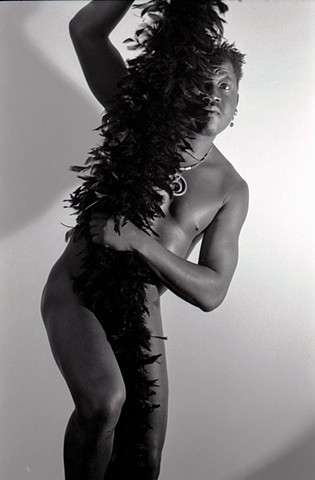 black man naked with black feather boa looking like Josephine Baker era Harlem Rennassaince  dancer by La mouge Erotic photo