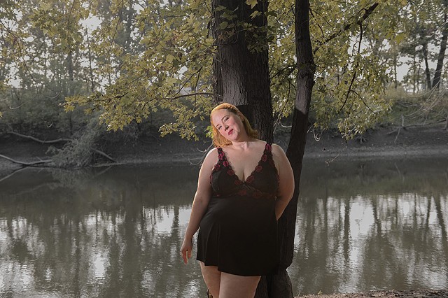 a plump beautiful woman stands by a river looking sexy in her nightie in the woods by erotic photo La Mouge Photo